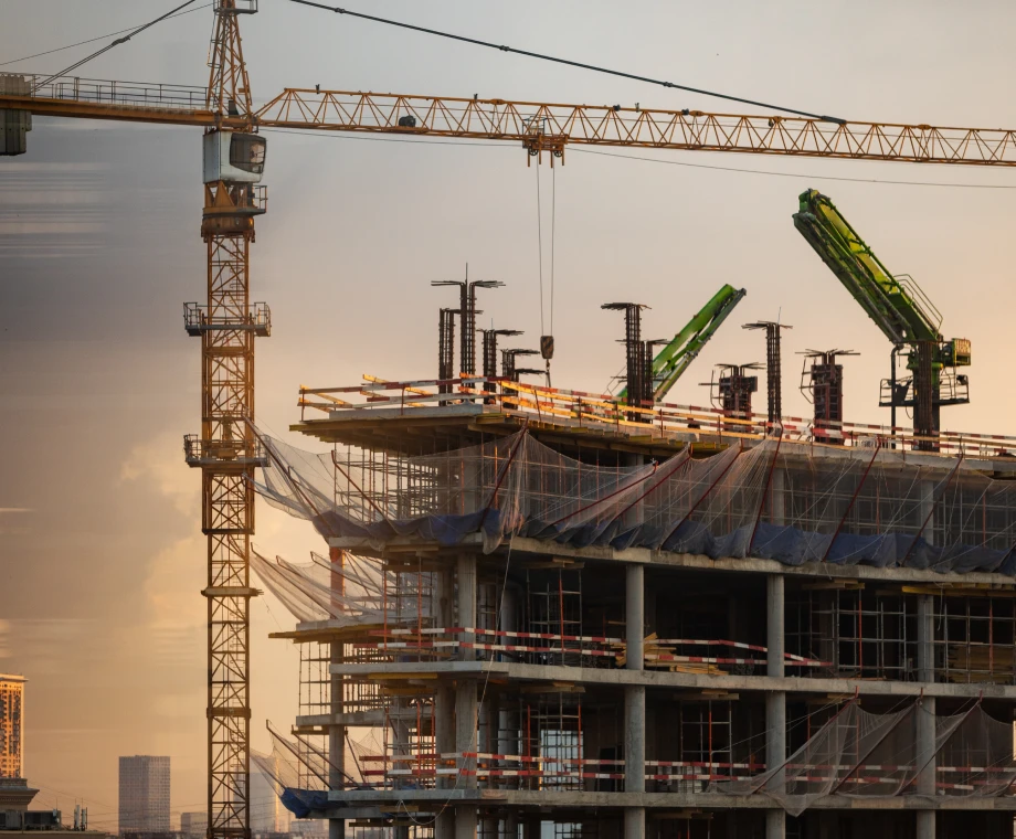 Urban construction scene with cranes and scaffolding